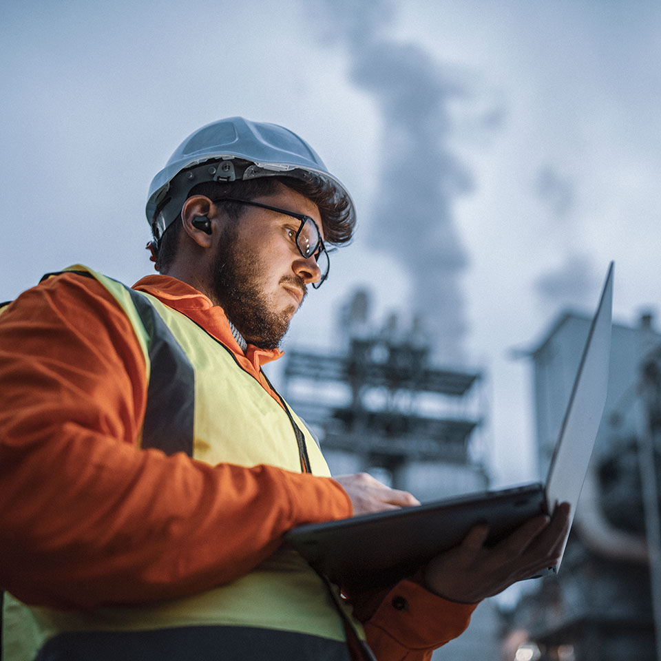 Engineer using laptop on site